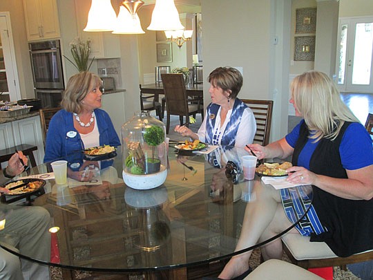 Crickett Huff, Dottie Lay and Robin Rawald, Coldwell Banker Premier, take some time to chat at D.R. Horton's new model opening at Murabella.