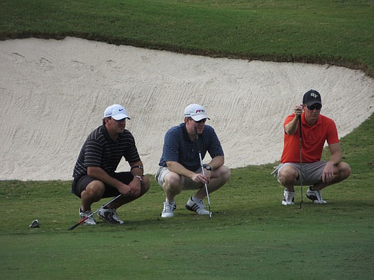 Last year's winning team studies options for this shot. Team members (from left) are Tyler Fugitt, team captain Bryan Rendzio (Franson, Iseley &amp; Rendzio) and Brent McGinnis.