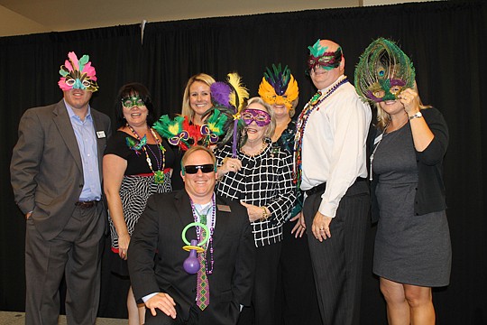 This year's Realtor-Builder Trade Show will be a Mardi Gras-themed event. Planning committee members, from left are Aaron Bacus of First Guaranty Mortgage Corp., Janna Thomas of First Equity Mortgage Bankers Inc., Palmer Kuder of NEFBA, Selby Kaiser o...