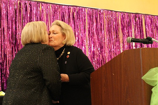 Outgoing NEFAR President Linda McMorrow (left) thanked her sister, Selby Kaiser, for her extra work managing their brokerage, The Legends of Real Estate, while McMorrow led the association.