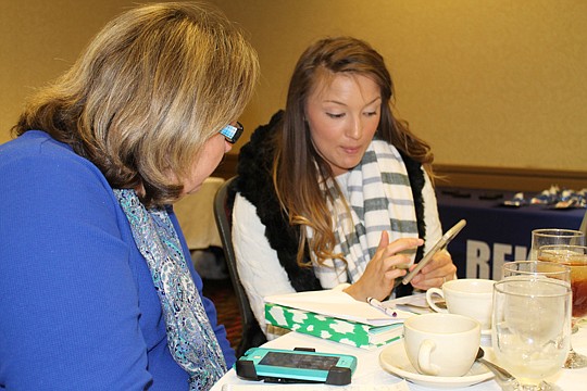 Bailey Jordan of Navy to Navy Homes shows Melissa McCall Owen of Deltona Realty an app she uses for property management. Realtors and affiliates swapped tips at a February roundtable lunch of the Northeast Florida chapter of the National Association o...