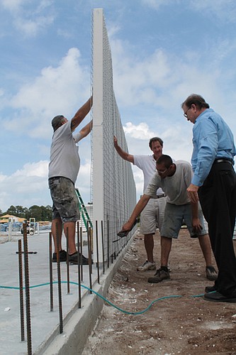 Lee Arsenault (right), general contractor for elacora in Jacksonville, is building homes with structural concrete insulated panels, or SCIPs.  The panels are made with insulating foam sandwiched between reinforced steel that are covered with concrete ...