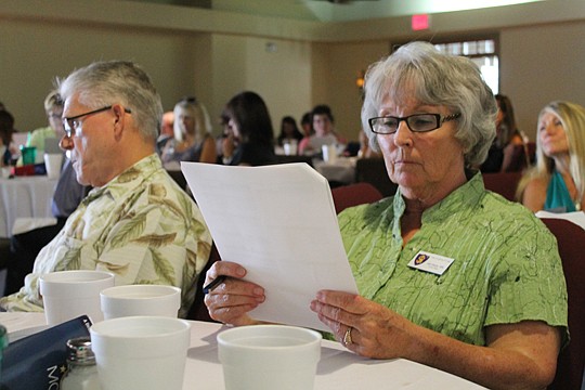Gail Dasta, broker at Salus Realty, studies new TILA-RESPA disclosure forms at a June training seminar. The documents help consumers understand what they owe before taking out a mortgage. The consumer protection bureau, which created the forms, has pr...