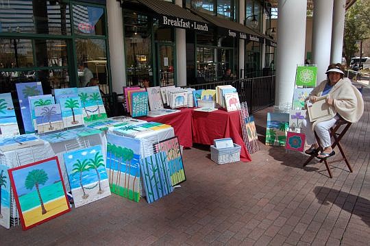 Painter E Meredith exhibited her tropical-theme art Friday at the Jacksonville Landing.