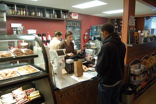 Diane Rukab, owner of the Brick Coffee House along West Adams Street in the Ed Ball Building, serves a customer.