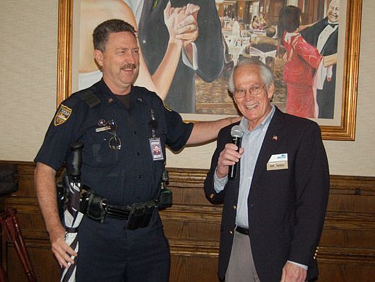 Officer Wally Butler was recognized for 35 years of service with the Jacksonville Sheriff's Office by Pat Geer, past president of the Downtown Council. Friday is Butler's last day on the Downtown beat.