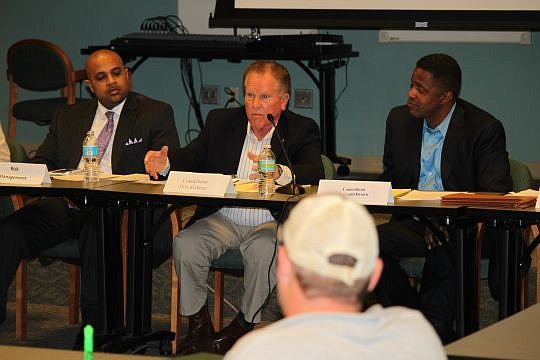 City Council member Don Redman talks of how a group crafting legislation for food trucks does not want to take away business from brick-and-mortar establishments. "Hang in there with us," he told the crowd of about two dozen Monday. Council member Reg...