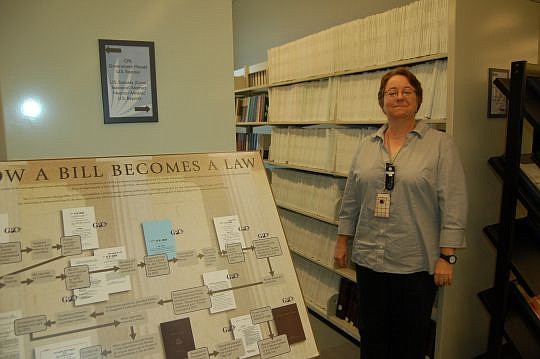 Krizek with a selection of government documents, including the past several years' federal budgets and other legal documents.
