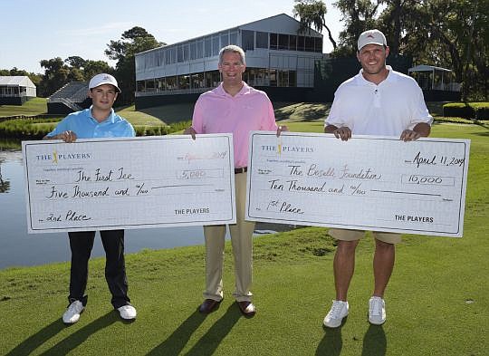 From left, Spencer Schindler, representing The First Tee of North Florida, with The Players Executive Director Matt Rapp and Tony Boselli, representing The Boselli Foundation.
