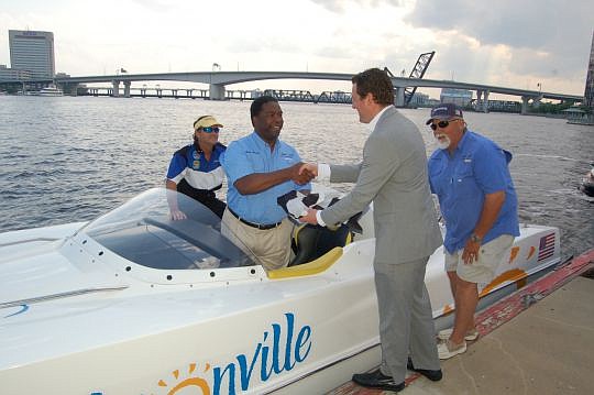 Mayor Alvin Brown climbed into the Visit Jacksonville Powerboat P1 to accept a checkered flag from Powerboat P1 CEO James Durbin on Thursday at the Jacksonville Landing while city Dock Master Capt. Jim Suber steadied the vessel. Read more about the re...