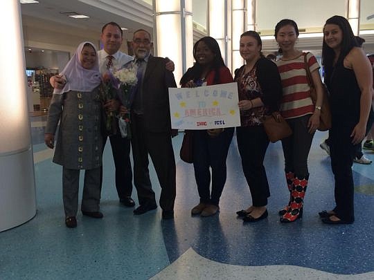 Florida Coastal School of Law students at the airport with their client, Sakina, to welcome her husband, Rajabili, upon his arrival to the United States.