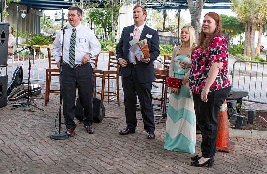 From left, Shea Moser, John Wallace, Lindsey Sheppard and Andrea Siracusa conduct the raffle to benefit Dreams Come True at the 2014 Rendezvous on the River. The sixth annual event is part of The Jacksonville Bar Association's Law Day observance.