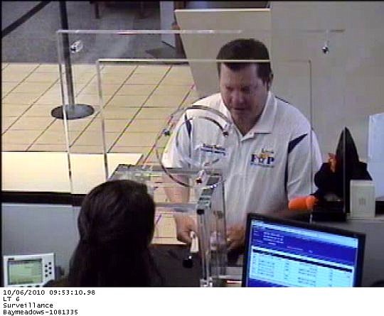 Robbie Freitas, shown in a bank surveillance photo, making a withdrawal.