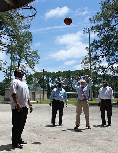 Attorney Steve Pajcic shoots some hoops with (from left), City Council member Johnny Gaffney, Mayor Alvin Brown and Edward Waters College President Nat Glover. The four took to the court for a few shots after it was announced Monday in Woodstock Park ...