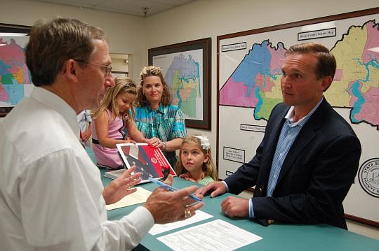 Lenny Curry (right) made his candidacy for mayor of Jacksonville official at 9:30 a.m. today. His wife, Molly, their daughters Bridget (sitting on counter) and Brooke, and their son, Boyd (not pictured), were also there. At left is Supervisor of Elect...