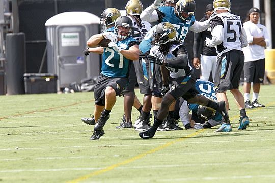 Running back Toby Gerhart tries to avoid a tackle during camp.
