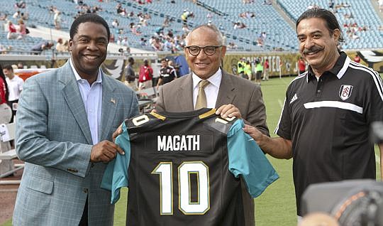 Mayor Alvin Brown (left) and Khan (right) present Fulham FC' s manager Felix Magath with a jersey during pregame ceremonies Saturday.