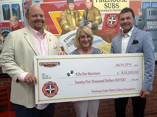 From left, Firehouse Subs co-founder and Foundation Chairman Robin Sorensen, K9s For Warriors President Shari Duval and Firehouse Subs co-founder and foundation Secretary Chris Sorensen.