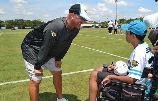 Jacksonville Jaguars head coach Gus Bradley talks game plan with 14-year-old Taubri Jackson.