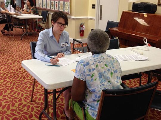 Pro bono attorney Sally Anne Brown assists a client with her advance directives.