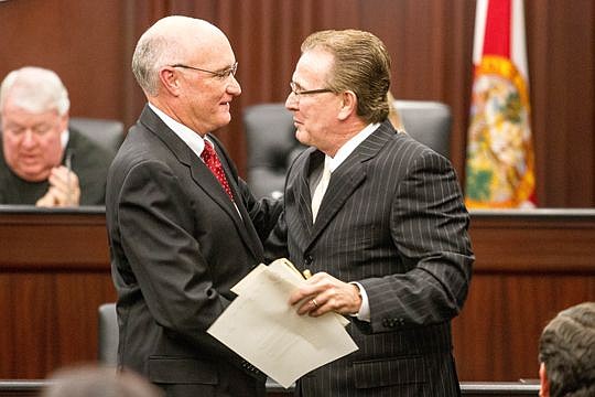 Circuit Court Judge Russell Healey (left) is congratulated by Clerk of Courts Ronnie Fussell.