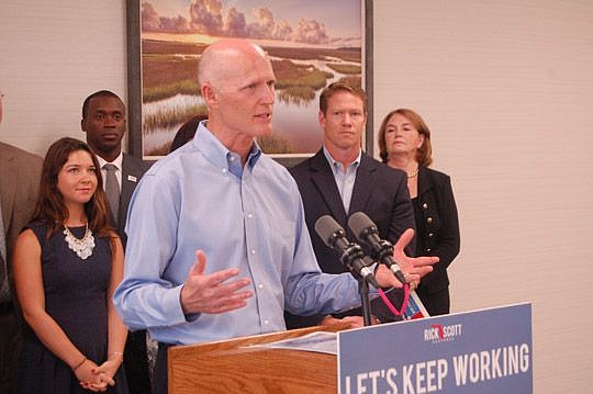 Gov. Rick Scott was in Jacksonville on Monday, promoting $41 billion in improvements to Florida's roads, ports, airports and the aerospace industry. At right are Daniel Davis, president and CEO of the JAX Chamber, and Donna Harper, chair of the Jackso...