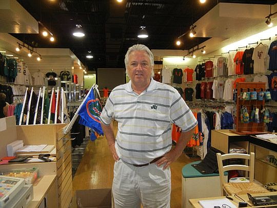 Tom Phillips owns the Sports Mania store at Regency Square Mall. He says it will take time to alter the perceptions of the Arlington mall but wants shoppers to check out the changes.