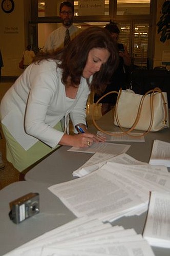 Aug. 1, 2012: Tatiana Salvador, then an attorney, now a circuit judge, signed the first petition to place a straw referendum on Tuesday's primary election ballot in support of Jacksonville's public libraries.