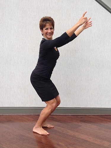 Giselle Carson, president-elect of The Jacksonville Bar Association, demonstrates proper air squat form to fight sedentary tendencies in professionals who sit for long periods of time.