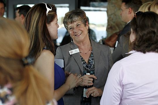 K.C. Padget from the North Florida Financial Corp. enjoys the conversation at the Jacksonville Women Lawyers Association's opening reception at Fionn MacCool's on Thursday.