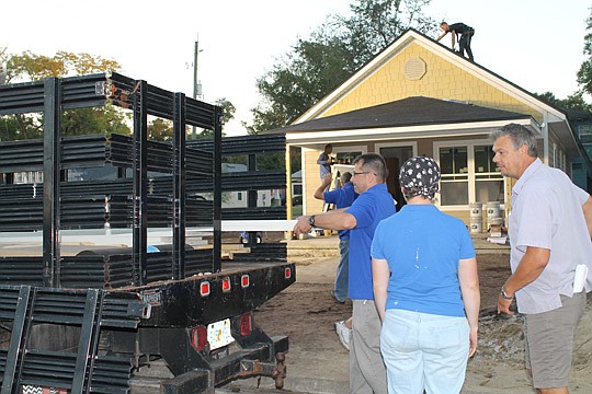 Project supervisor Kenny Gau, right, checks a delivery for the 24-hour HabiJax "blitz-build" as workers unload materials. HabiJax and the Northeast Florida Builders Association partnered to build a home in 6 a.m. to 6 p.m. shifts Oct. 14 and 15.