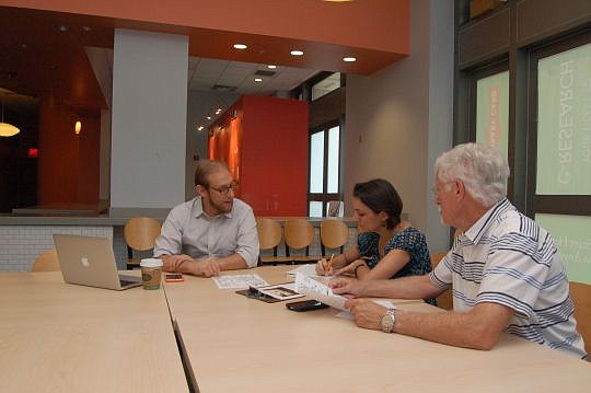 Friends of Hemming Park Executive Director Vince Cavin (left) consulted Tuesday with Lauren Stephens, a designer from Workscapes, joined by Wayne Wood, Friends of Hemming Park board chairman.