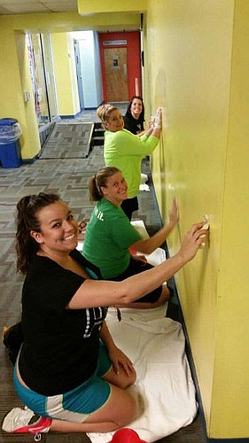 From the bottom, Publix employees Alexis Tatum, Laura East, Brittany Adams and Rebecca Stewart do volunteer work at the YMCA.