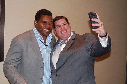 After a news conference Tuesday, former University of Georgia and NFL running back Herschel Walker posed for a selfie with Congregation Ahavath Chesed Senior Rabbi Joshua Lief, chairman of JCCI's board of directors.
