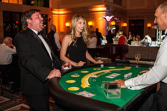 Sometimes you win, sometimes you lose. Eric Blocker, left, laughs as he loses a hand at blackjack while his wife, Amanda Blocker, wins. The theme this year was the Rat Pack, dating back to the days of Frank Sinatra, Dean Martin and Sammy Davis Jr. in ...