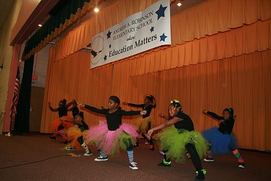 Members of Andrew Robinson Elementary School's dance group perform Saturday. The Friends of Andrew A. Robinson Foundation presented a $20,000 contribution to the school, located at 101 W. 12th St.