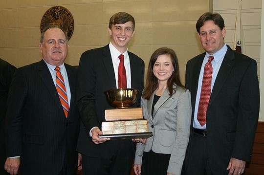 The University of Georgia won the 34th annual Florida-Georgia moot court competition Friday at the U.S. Courthouse in Jacksonville. From left are organizer Lanny Russell of Smith Hulsey &amp; Busey; University of Georgia law students Aaron Parks and J...