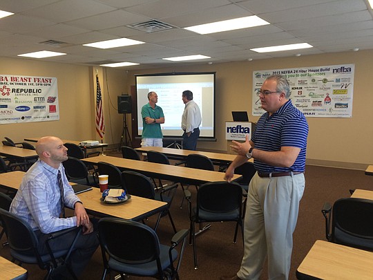 Cecil W. Powell &amp; Co. account executive John Cotton discusses online marketing with Web.com's Dan Broze following a Nov. 19 Northeast Florida Builders Association lunch-and-learn seminar.