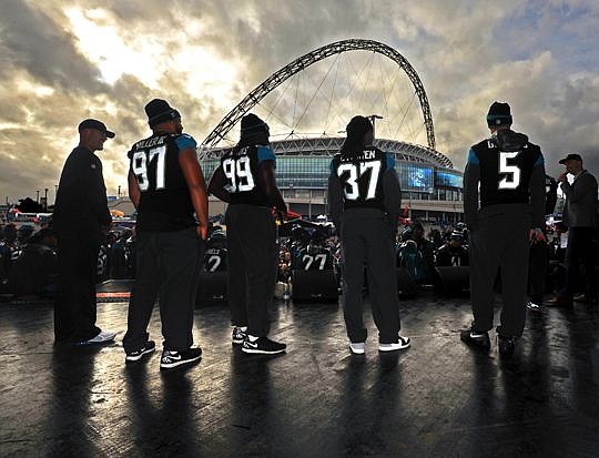 Jacksonville Jaguars head coach Gus Bradley (right) and members of the team are onstage with Wembley Stadium in the background during the NFL All-Access fan rally Saturday in London.  (This photo is not for sale.)