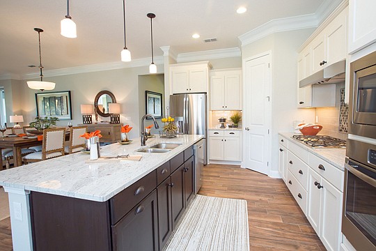 The heart of the Arcadia show home is its gourmet kitchen, which opens to the living room and features a center island and cafe.