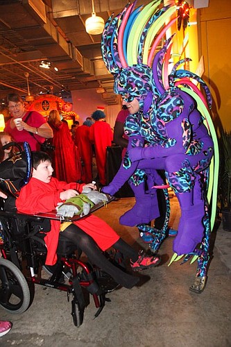 Community PedsCare patient Alex Tiencken met one of the Atmosphere Jumpers at the 10th annual Halloween Doors &amp; More event.