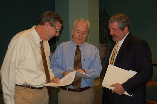 From left, Jim Klement, Office of Economic Development redevelopment coordinator; developer Mike Langton; and Jim Bailey, Downtown Investment Authority member, talk after Monday's meeting with potential applicants for retail enhancement grants. Bailey...