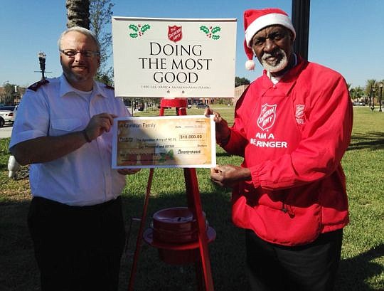 Left, Maj. Thomas McWilliams, area commander of Salvation Army of Northeast Florida, and Red Kettle bell ringer Harold Pierce with the largest anonymous donation received by the nonprofit.