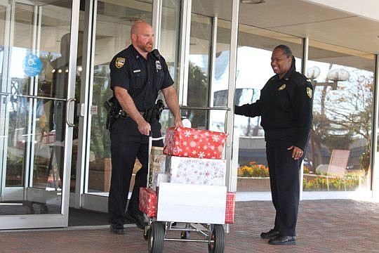 Officer Chris Jackson and Lt. Lakesha Burton helped load and deliver the JBA's presents to area seniors last week.