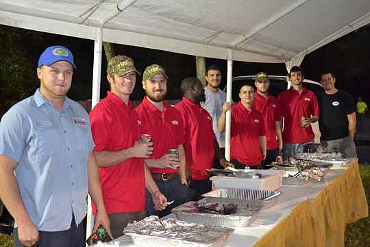 Dressed in their red Apprenticeship Program shirts, fourth-year apprentices served up pulled pork, baked beans and cole slaw with banana pudding for dessert.
