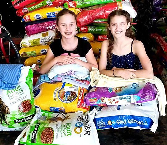 Cate Goodwyne, left, and Grace Vosmik donated food and linens to First Coast No More Homeless Pets.