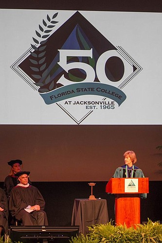 Cynthia Bioteau unveils the 50-year anniversary logo for Florida State College at Jacksonville during her investiture Friday. Bioteau has been president at FSCJ for a year, after working at Salt Lake Community College in Utah.