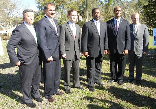 From left, Jacksonville University President Tim Cost, City Council member John Crescimbeni, council President Clay Yarborough, Mayor Alvin Brown, JEA Government Affairs Director Wayne Young and Brad Thoburn, JTA vice president of long range planning ...