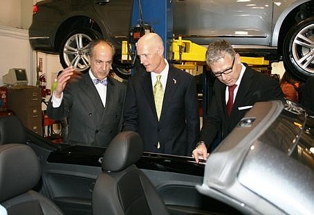 Volkswagen Group of America's David Geanacopolos (left), Florida Gov. Rick Scott and Volkswagen Group's Jan Bures check out a new Volkswagen Beetle convertible Wednesday at an Amports Inc. vehicle processing facility in Jacksonville. Geanacopolos is V...