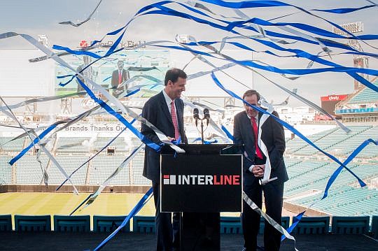 Kenneth Sweder, president and COO of Interline Brands, and Michael Grebe, the company's chairman and CEO, are surrounded by streamers during a news conference announcing the launch of a new brand, SupplyWorks.